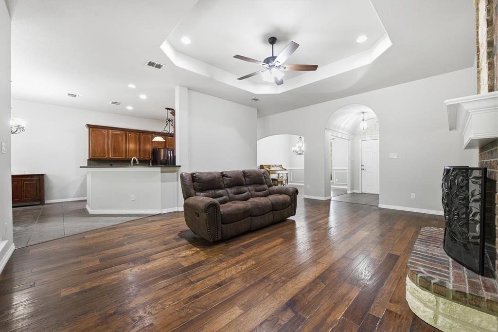 5992 Red Bud Road Fort Worth, TX 76135 - Photo 12 of 40 a living room with furniture and a flat screen tv