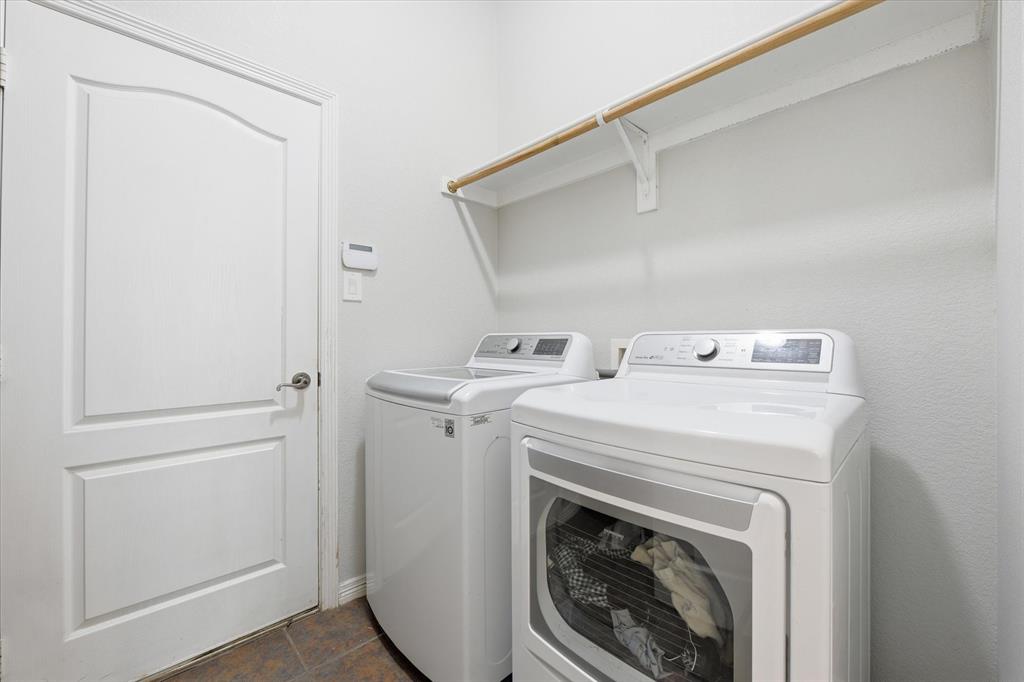 5992 Red Bud Road Fort Worth, TX 76135 - Photo 19 of 40 a utility room with dryer and washer
