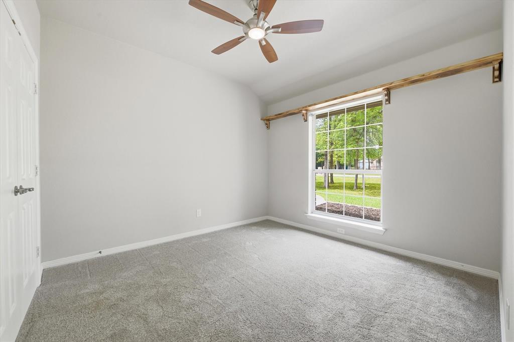 5992 Red Bud Road Fort Worth, TX 76135 - Photo 23 of 40 an empty room with a window and a ceiling fan
