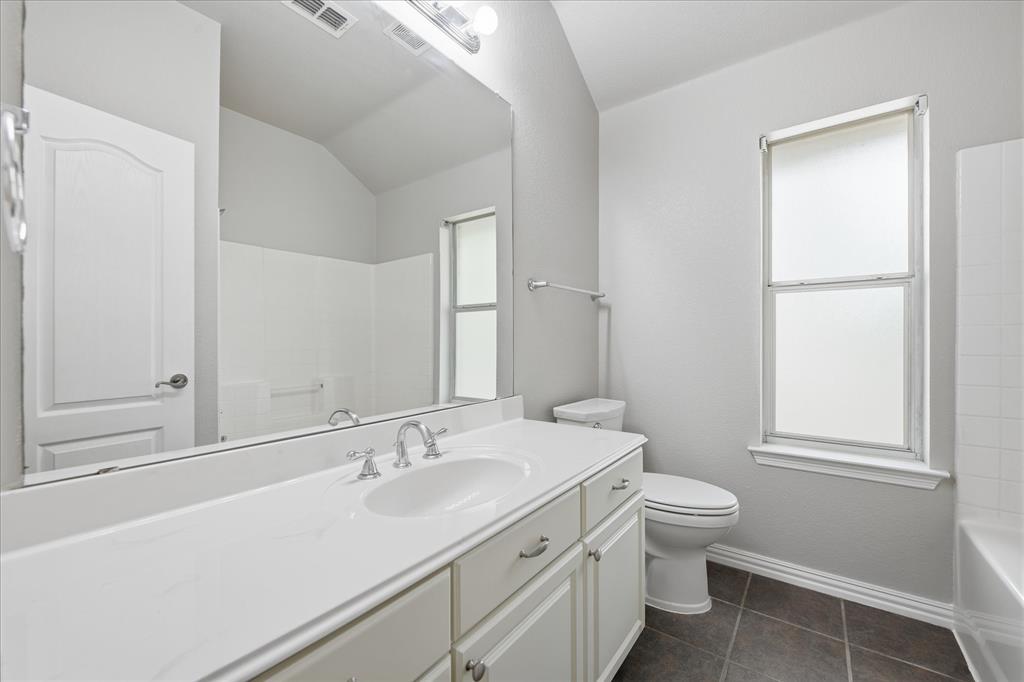5992 Red Bud Road Fort Worth, TX 76135 - Photo 28 of 40 a bathroom with a sink toilet and vanity