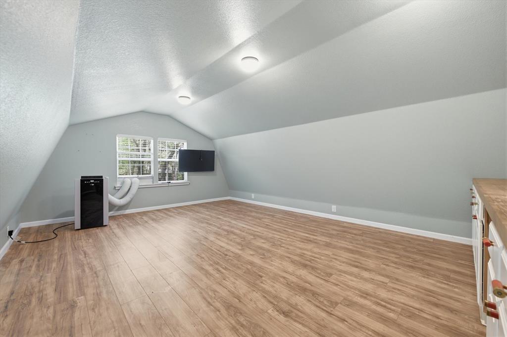 5992 Red Bud Road Fort Worth, TX 76135 - Photo 32 of 40 wooden floor in an empty room with a window