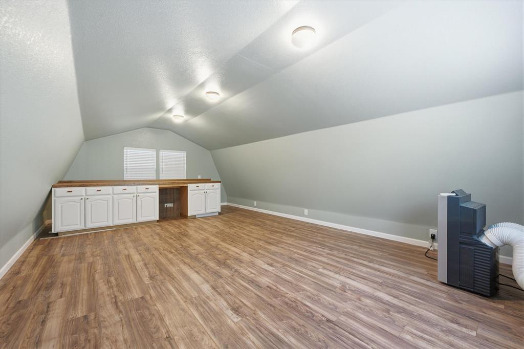 5992 Red Bud Road Fort Worth, TX 76135 - Photo 33 of 40 a view of a room with wooden floor and electronic appliances