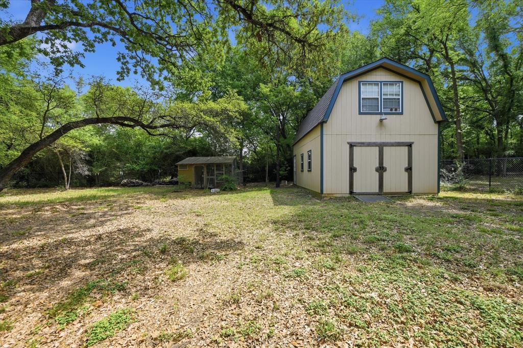 5992 Red Bud Road Fort Worth, TX 76135 - Photo 35 of 40 a view of a house with a yard