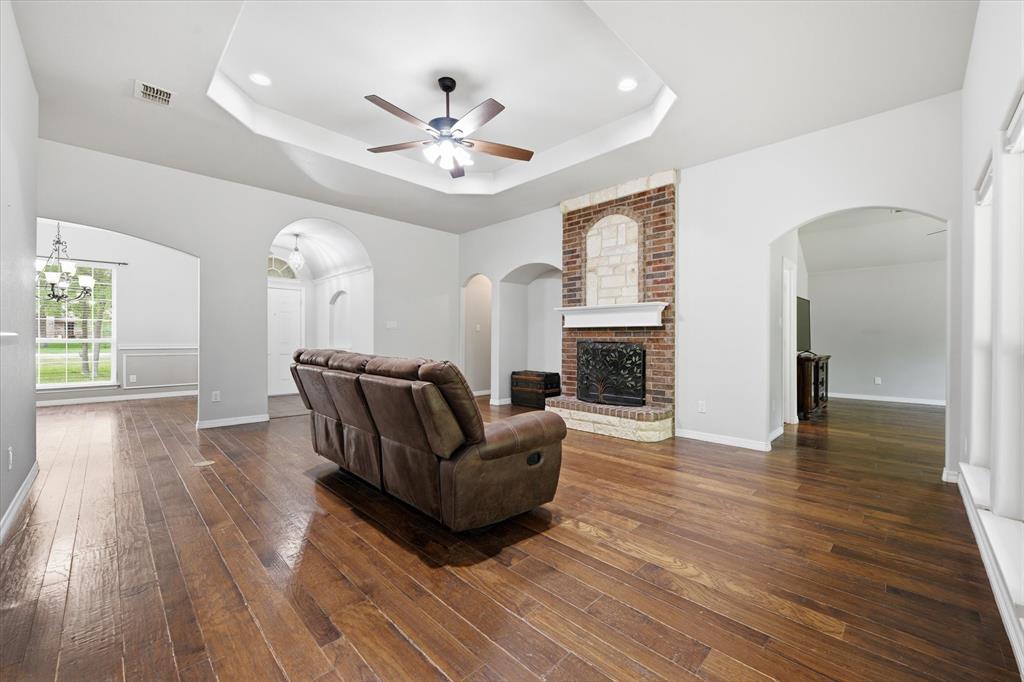5992 Red Bud Road Fort Worth, TX 76135 - Photo 7 of 40 a living room with furniture and a fireplace