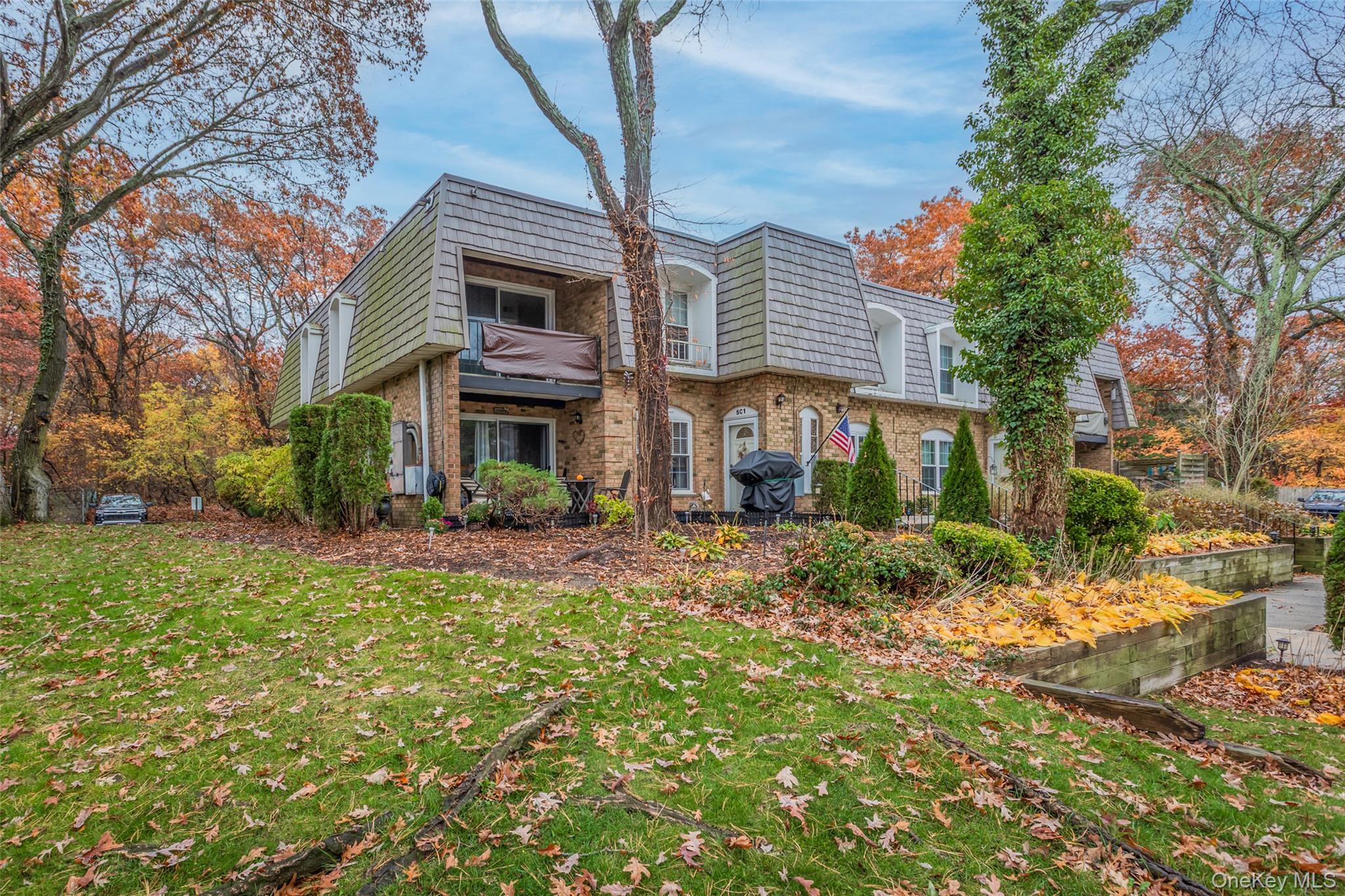 a view of a brick house with a yard