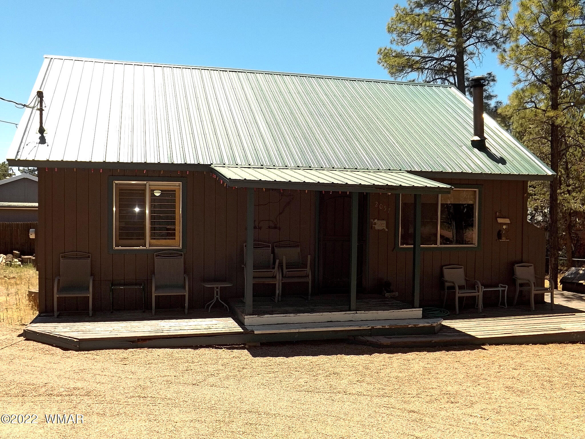 2057 Shot Gun Road Overgaard, AZ 85933 - Photo 2 of 24 a view of a house with a door and a yard