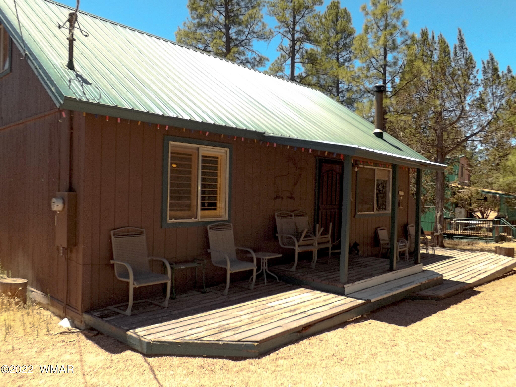 2057 Shot Gun Road Overgaard, AZ 85933 - Photo 3 of 24 a view of a patio with table and chairs near a barbeque