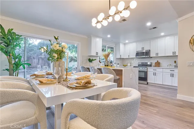 a view of a dining room with furniture and a kitchen