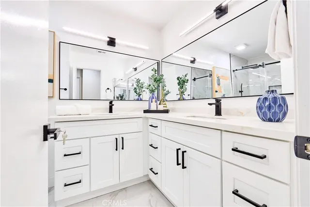 a bathroom with a sink vanity and mirror