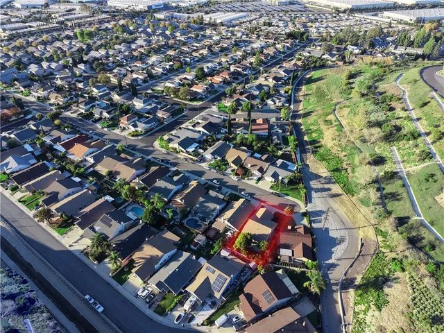 an aerial view of a house with a garden and trees