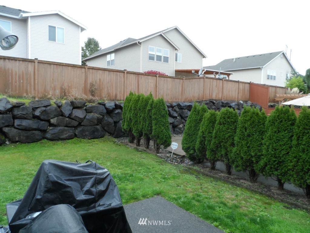 303 Index Place Southeast Renton, WA 98056 - Photo 14 of 14 a view of a backyard with couches plants and large trees