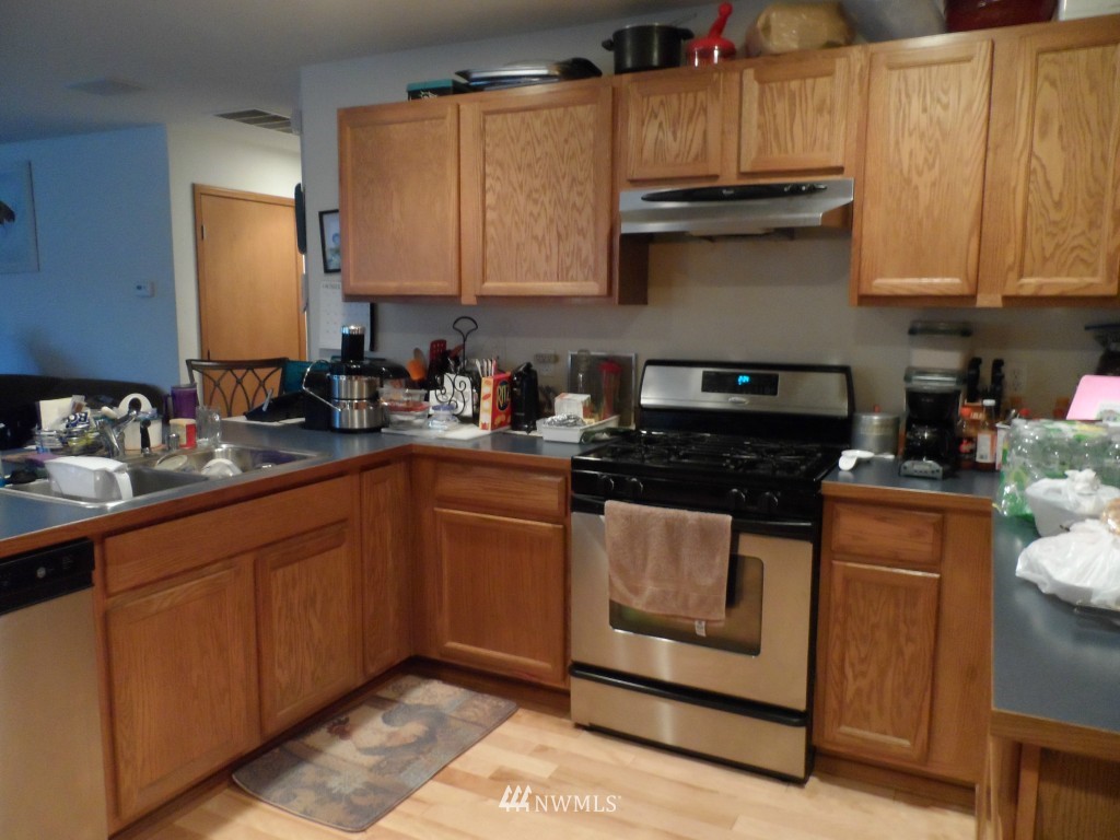303 Index Place Southeast Renton, WA 98056 - Photo 6 of 14 a kitchen with stainless steel appliances granite countertop a sink stove and cabinets