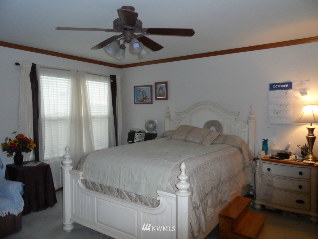 303 Index Place Southeast Renton, WA 98056 - Photo 9 of 14 a bedroom with a bed and a chandelier fan