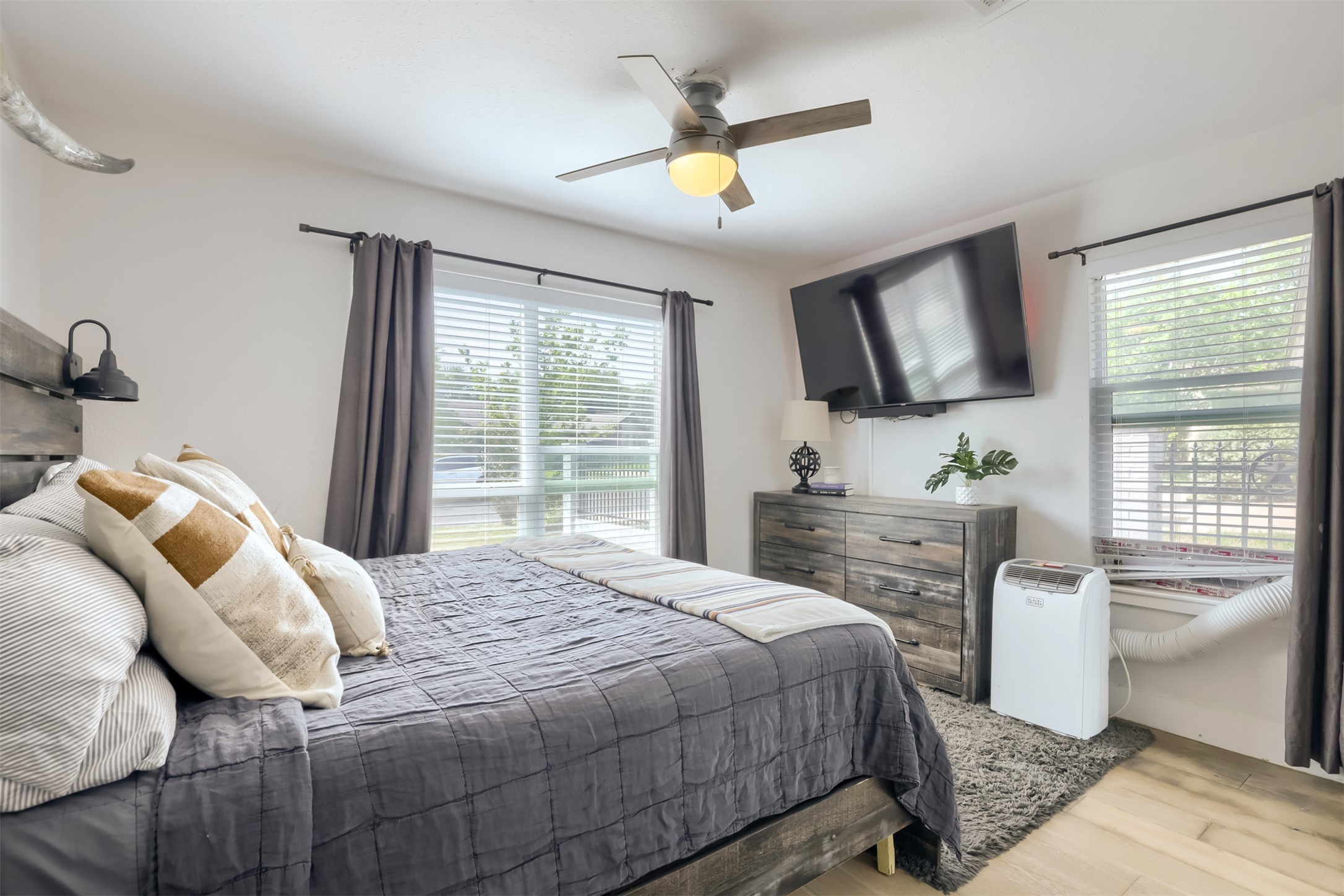 9016 West Pointer Lane Austin, TX 78758 - Photo 16 of 29 a bedroom with a bed a window and a flat screen tv
