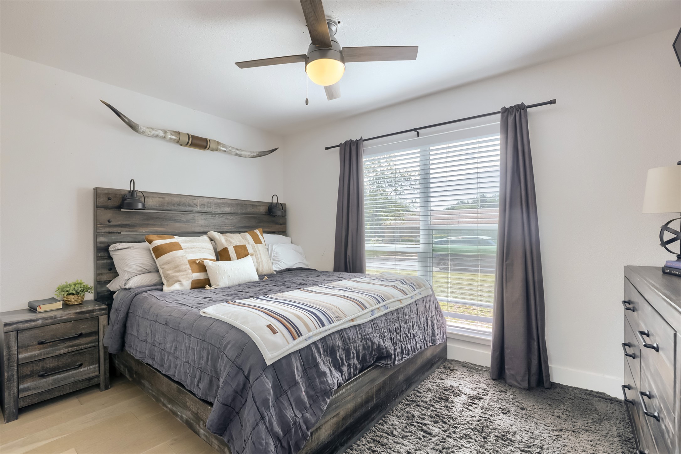 9016 West Pointer Lane Austin, TX 78758 - Photo 17 of 29 a bedroom with a large bed and a chandelier