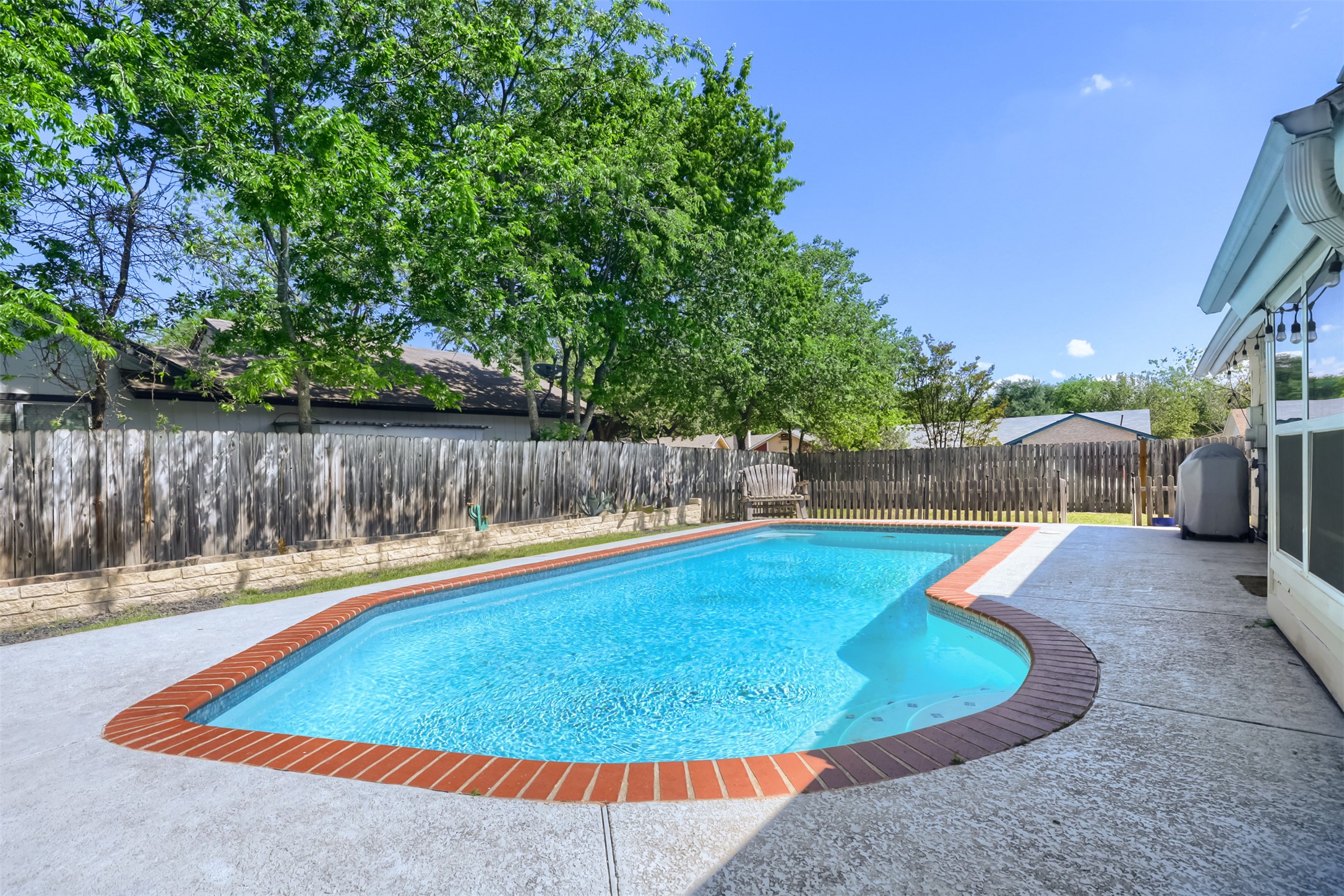 9016 West Pointer Lane Austin, TX 78758 - Photo 23 of 29 a view of a swimming pool with a patio and wooden fence