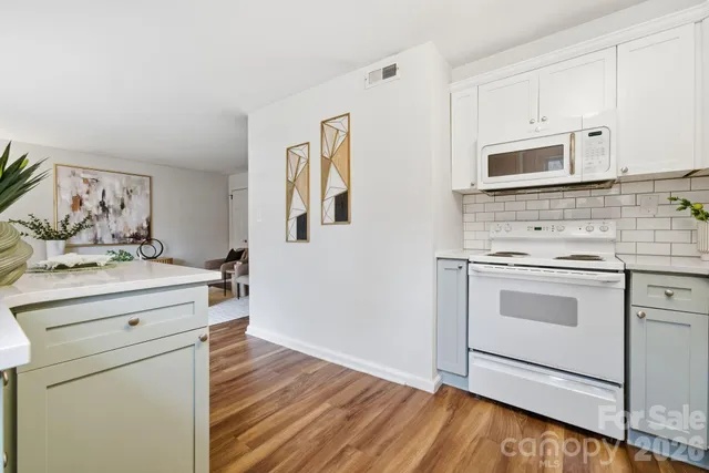 a kitchen with stainless steel appliances a stove microwave and cabinets
