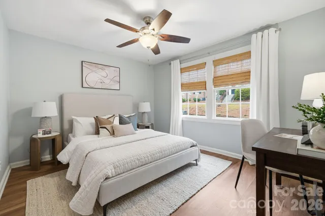 a bedroom with a large bed and a desk