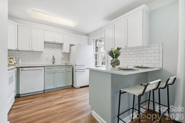 a kitchen with a sink cabinets and window