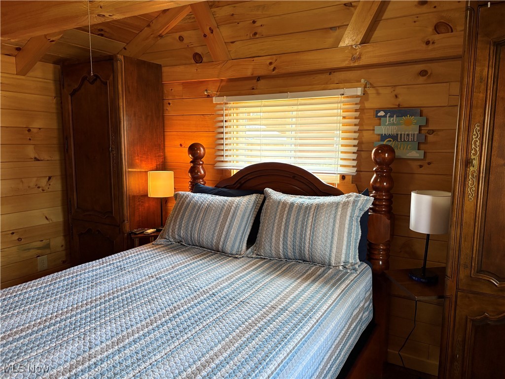 5919 Lake Road West, Unit 13 Ashtabula, OH 44004 - Photo 19 of 35 Bedroom with a wooden ceiling with exposed beams and wooden walls