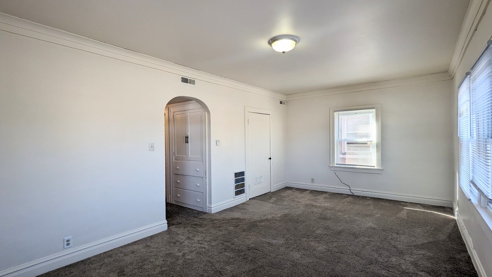 825 West Jefferson Street, Unit 2 Joliet, IL 60435 - Photo 3 of 6 an empty room with windows