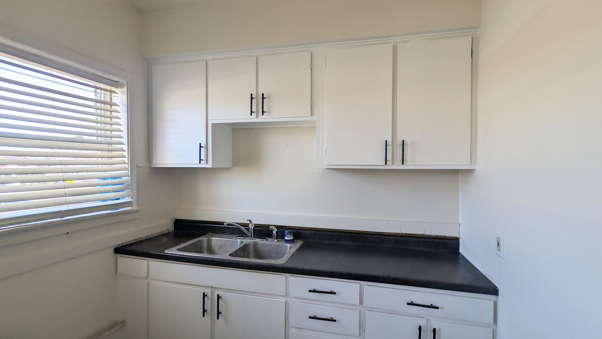 825 West Jefferson Street, Unit 2 Joliet, IL 60435 - Photo 6 of 6 a kitchen with white cabinets and sink