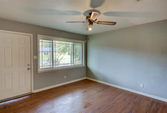 wooden floor in an empty room with a window