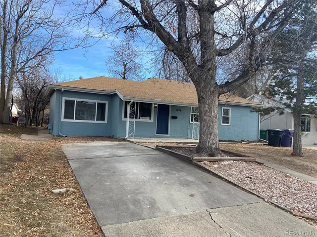 front view of a house with a large tree