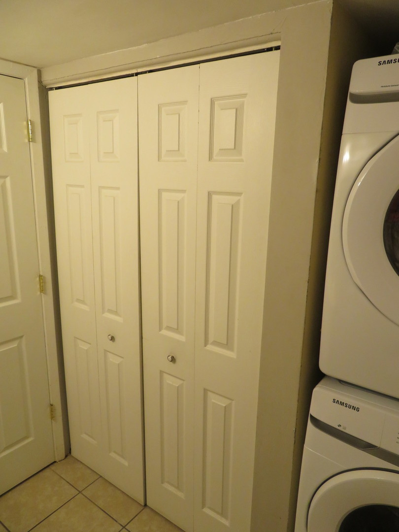 310 Rodenburg Road Roselle, IL 60172 - Photo 14 of 56 a view of a bathroom with a sink and a washer dryer