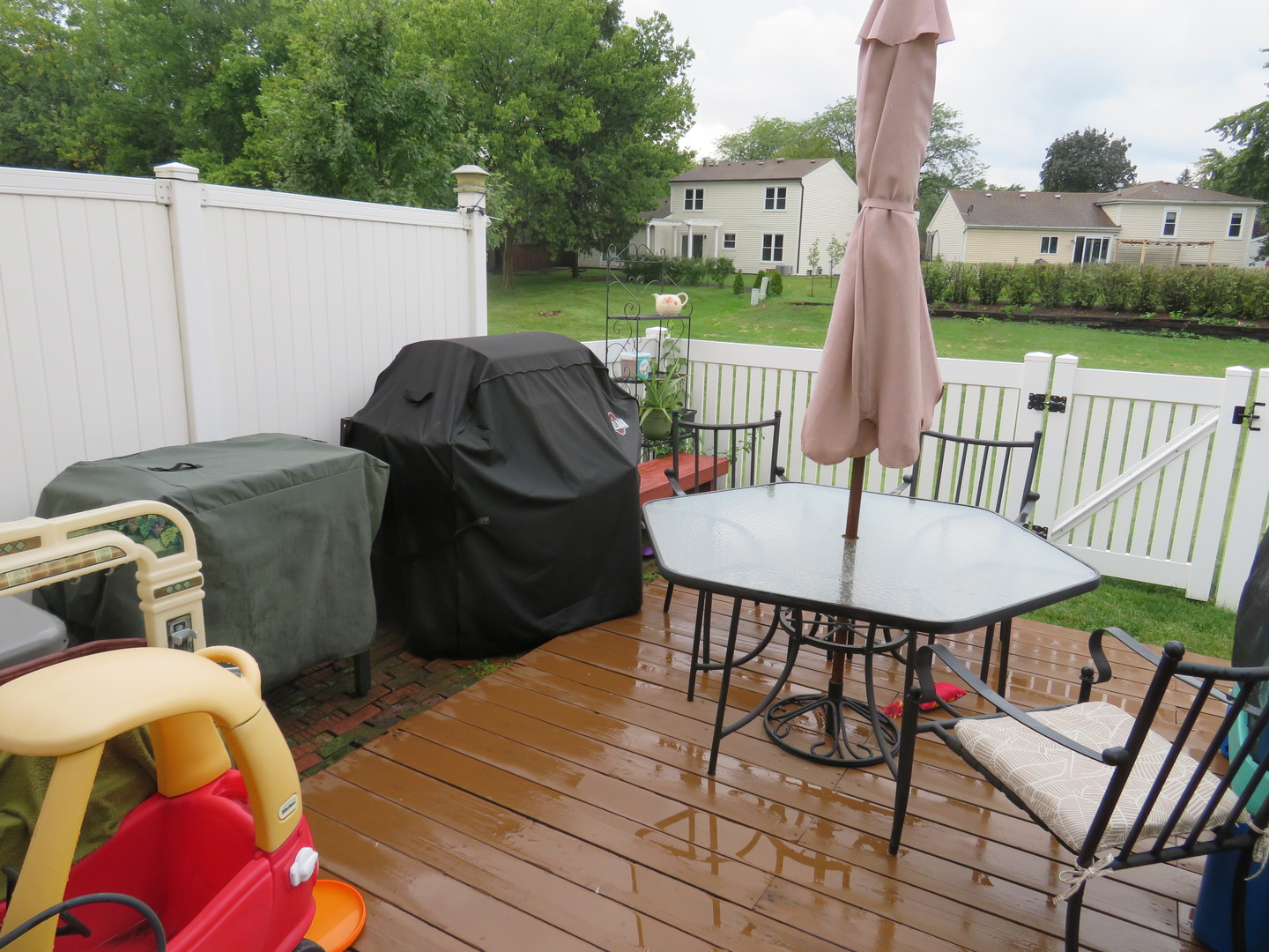 310 Rodenburg Road Roselle, IL 60172 - Photo 33 of 56 a view of a patio with table and chairs with wooden floor and fence