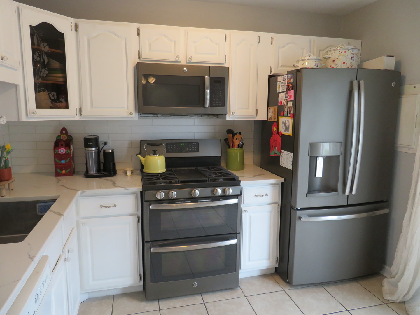 310 Rodenburg Road Roselle, IL 60172 - Photo 7 of 56 a kitchen with stainless steel appliances granite countertop a refrigerator stove and microwave