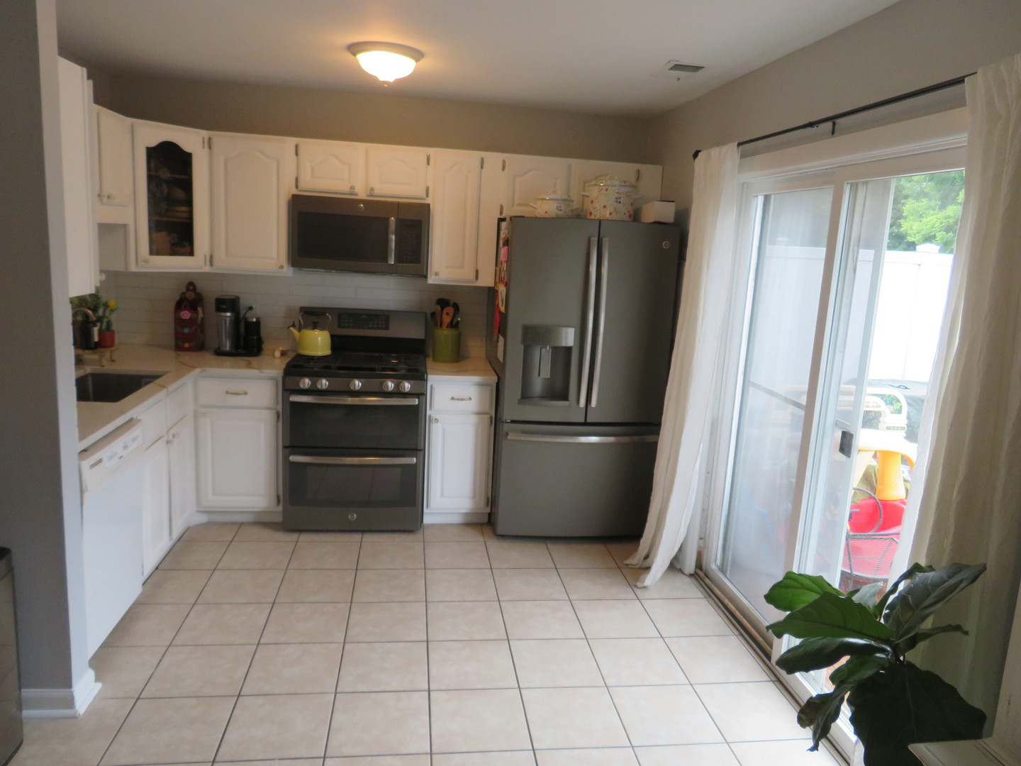 310 Rodenburg Road Roselle, IL 60172 - Photo 10 of 56 a kitchen with stainless steel appliances a refrigerator sink and microwave