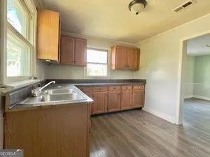 a kitchen with a sink a window and cabinets
