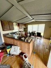 a kitchen with granite countertop a stove a sink and a dining table