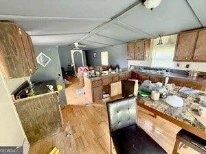 a kitchen with stainless steel appliances granite countertop a sink stove and cabinets