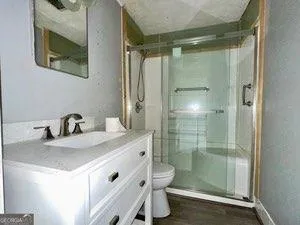 a bathroom with a granite countertop sink mirror and shower