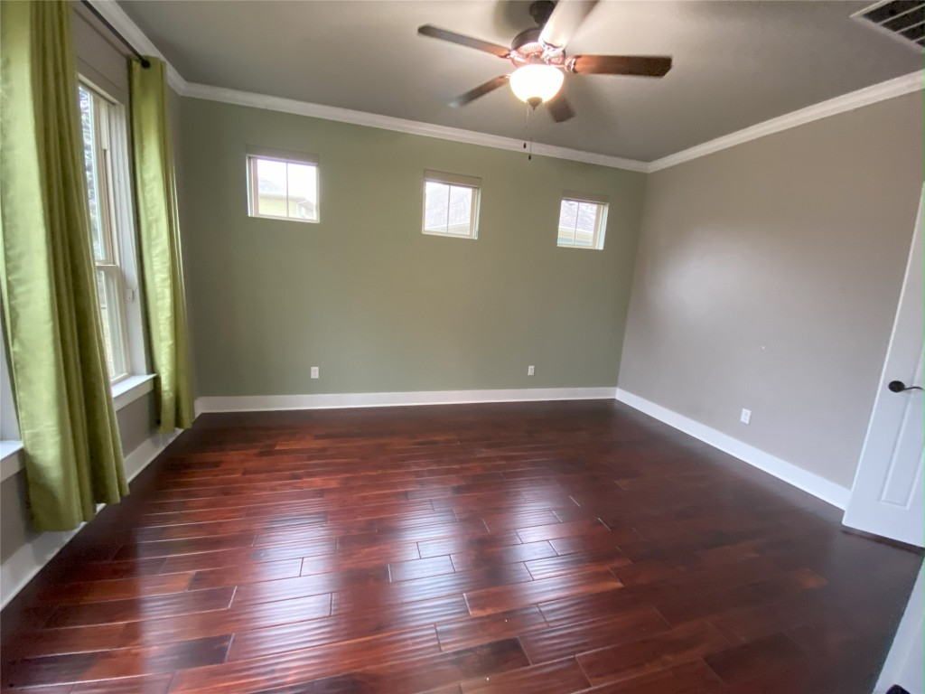 11200 Avery Station Loop, Unit 13 Austin, TX 78717 - Photo 18 of 39 an empty room with wooden floor fan and windows