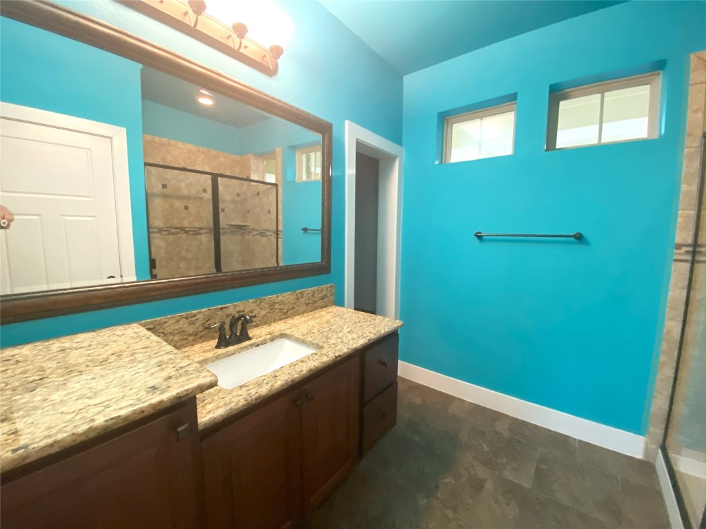 11200 Avery Station Loop, Unit 13 Austin, TX 78717 - Photo 19 of 39 a bathroom with a granite countertop sink and a mirror
