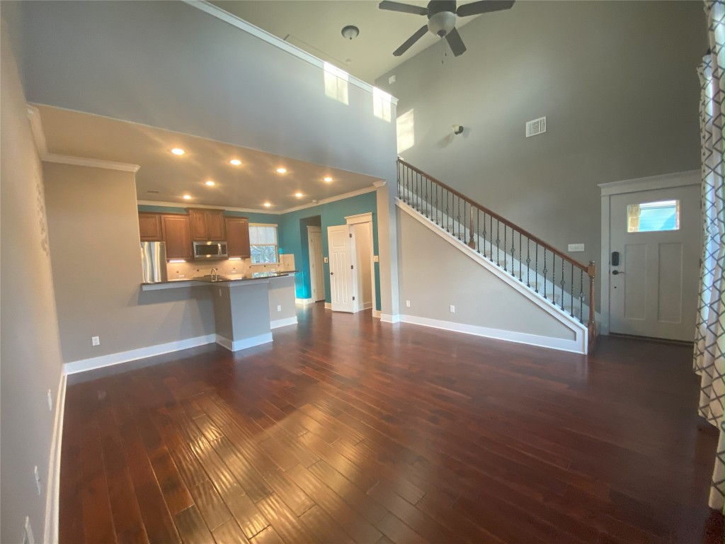 11200 Avery Station Loop, Unit 13 Austin, TX 78717 - Photo 2 of 39 a view of a hallway with wooden floor and a chandelier