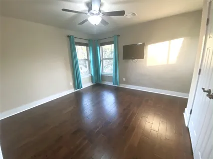 a view of wooden floor and windows in a room