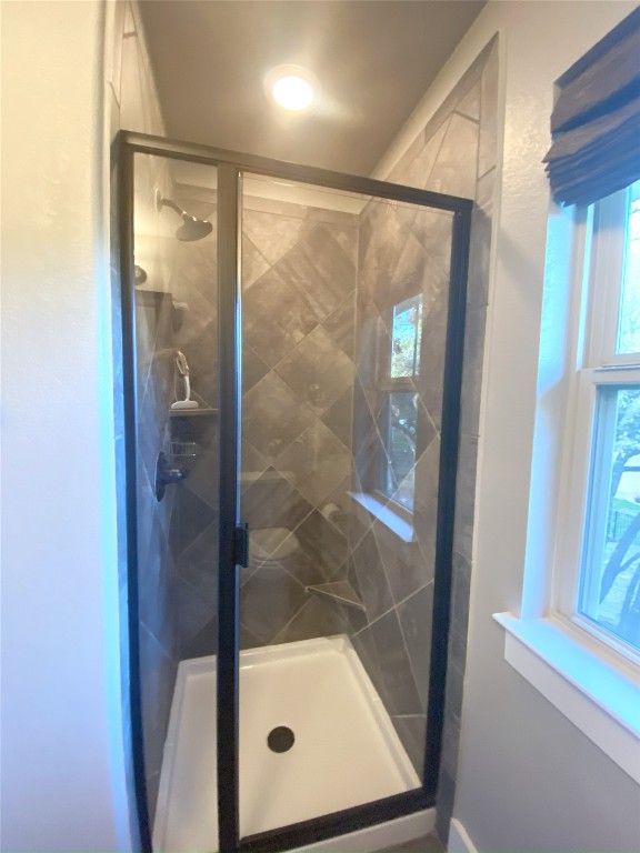 11200 Avery Station Loop, Unit 13 Austin, TX 78717 - Photo 29 of 39 a bathroom with a glass shower door