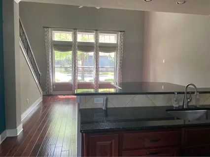 a kitchen with granite countertop a sink and a window