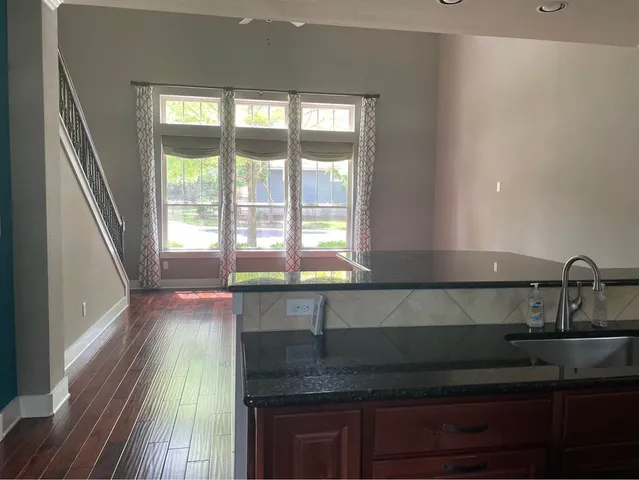 a kitchen with granite countertop a sink and a window