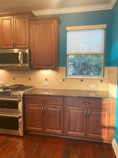 a kitchen with stainless steel appliances granite countertop a stove a sink and a microwave