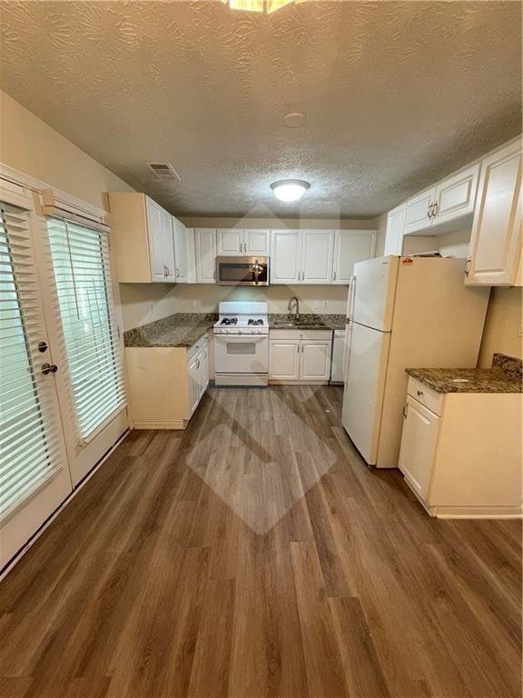 4267 Grogan Street Acworth, GA 30101 - Photo 9 of 37 a kitchen with a sink appliances and cabinets