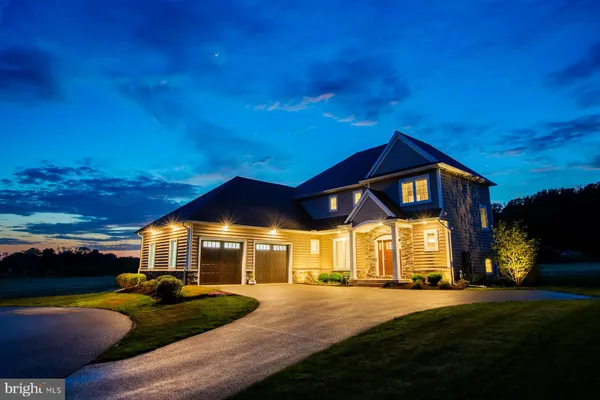 a front view of house with yard and outdoor seating
