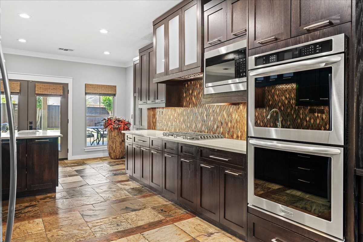 1502 Reimer Street Brenham, TX 77833 - Photo 3 of 30 a kitchen with stainless steel appliances kitchen island granite countertop a stove and a sink