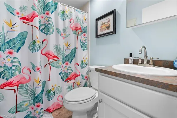 a bathroom with a sink mirror vanity and toilet