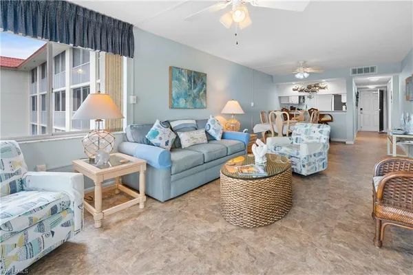 a living room with furniture and a chandelier
