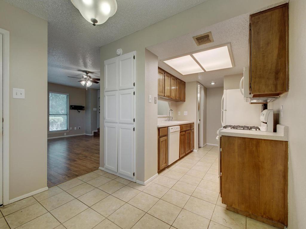 11301 Jollyville Road, Unit A3 Austin, TX 78759 - Photo 11 of 26 a kitchen with a refrigerator and a sink